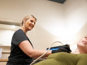 Natalie Moskalets, RDMS, smiling while performing an ultrasound scan for UltraVision Imaging