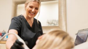 Our sonographer smiling as she scans a patient