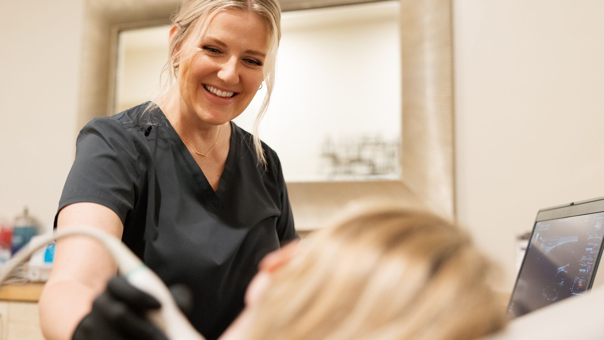 Natalie Moskalets smiling as she scans a patient
