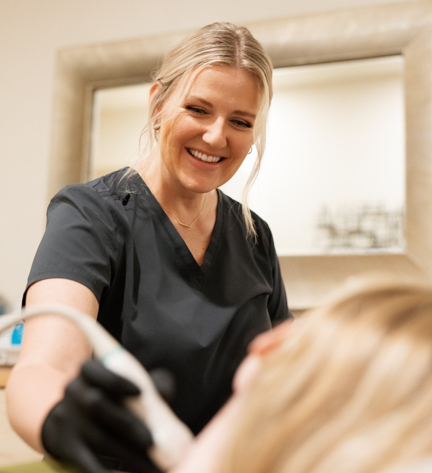 Natalie scanning a patient at the Roseville clinic